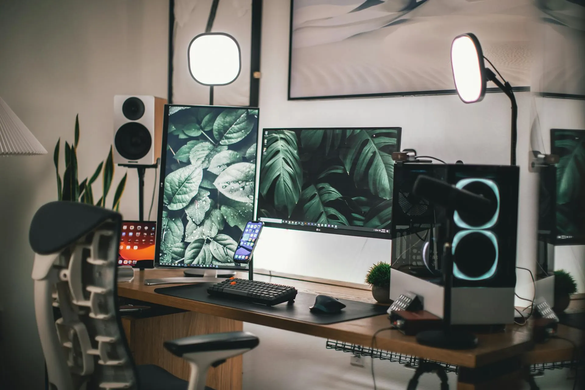 A hybrid gaming + creative workstation with streaming gear, a mic setup, and dual displays ready for work or play.